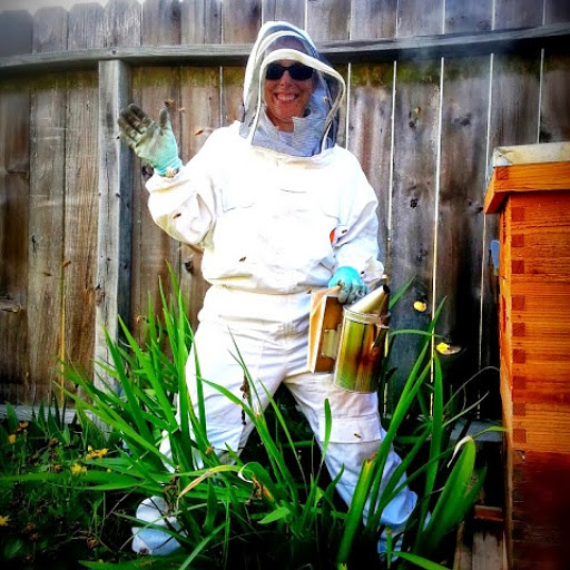 BZ Honey - Kelly inspects our hives to ensure their good health.